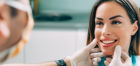 A dentist assessing the smile of their female patient