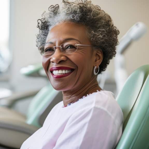 Smiling senior woman sitting in dental chair