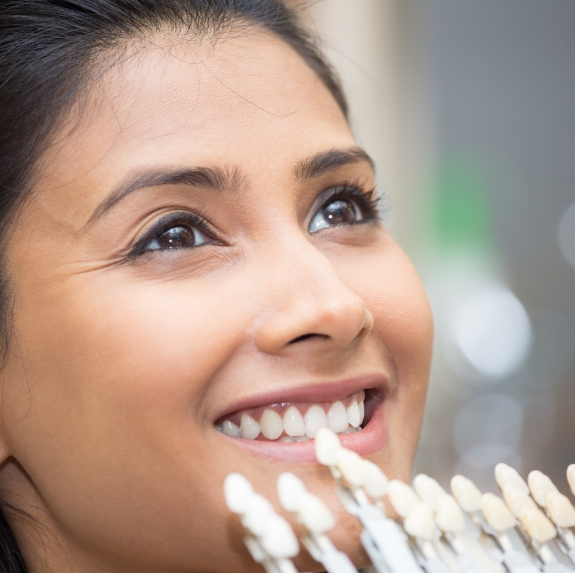 Smiling woman being fitted for dental veneers