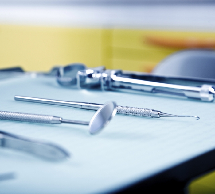 Row of dental instruments on tray