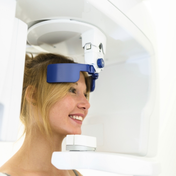 Dental patient receiving a C T cone beam scan of her jaw