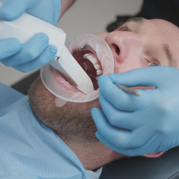 Man having digital dental impressions taken by dentist