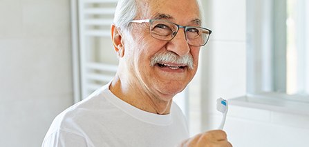 Patient in Putnam brushing their teeth after dentures