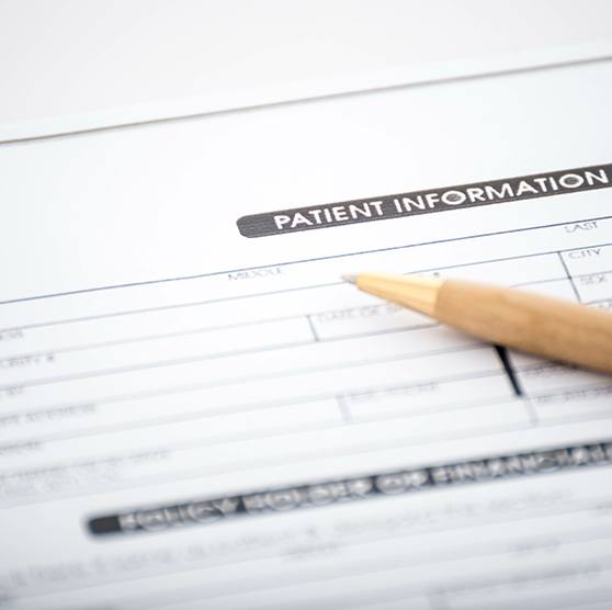 a patient form with a pen laying on top of it
