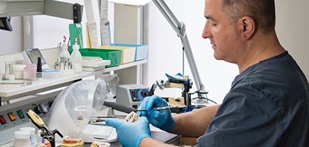 Dental technician in Putnam working on dentures