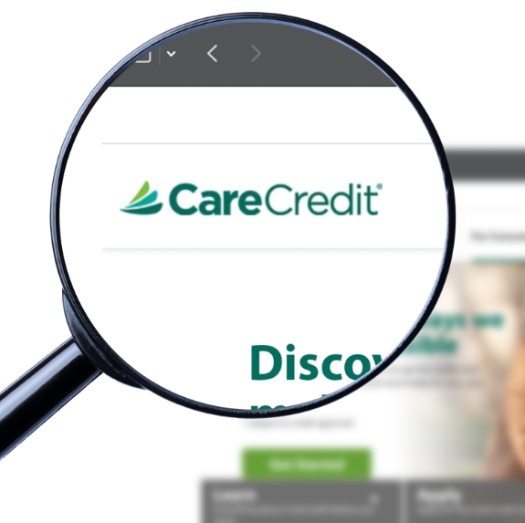Magnifying glass showing the CareCredit logo on their website