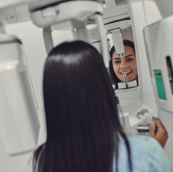 Woman getting a cone beam scan of her jaw in dental office