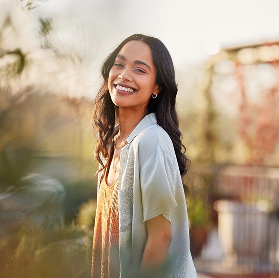 Woman smiling while standing outside