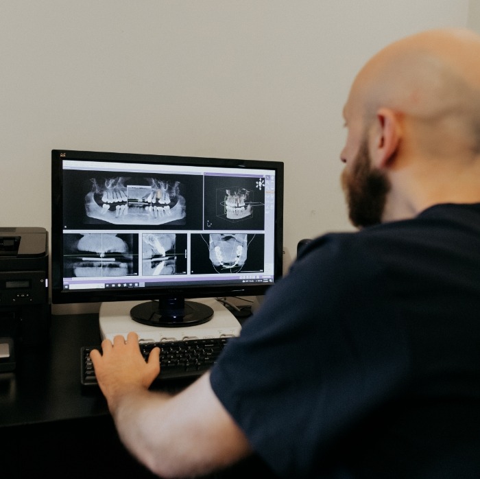 Doctor Moaz looking at dental x rays on computer