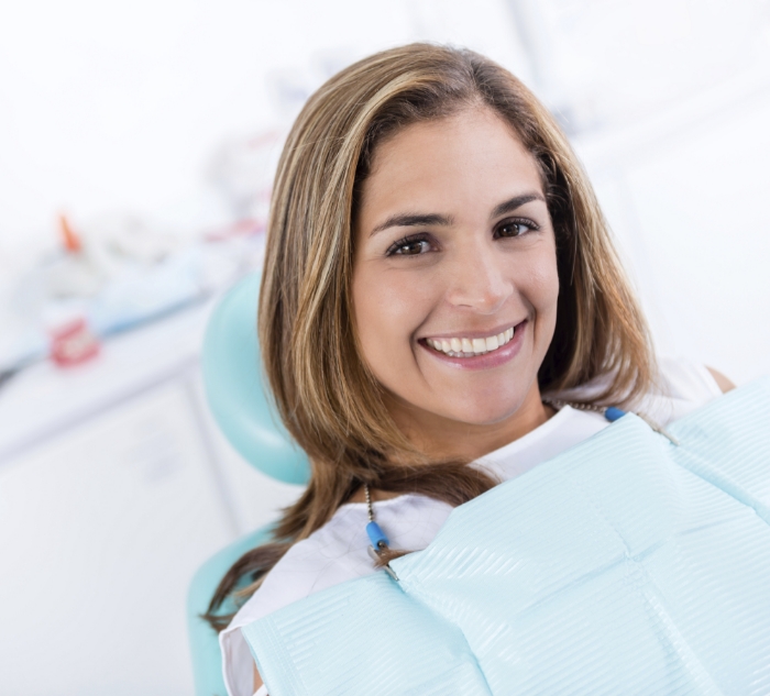 Smiling young woman in dental chair