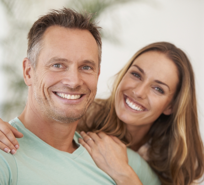 Man and woman smiling together after preventive dentistry visit