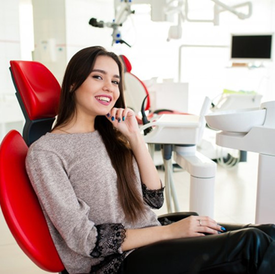 Woman smiling in the patient’s chair