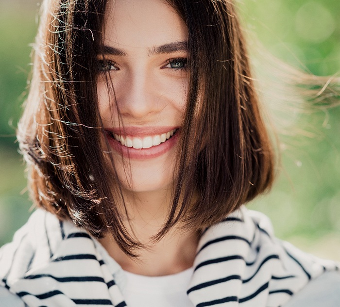 Closeup of woman with white teeth smiling